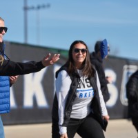 2 girls throwing bags in corn hole